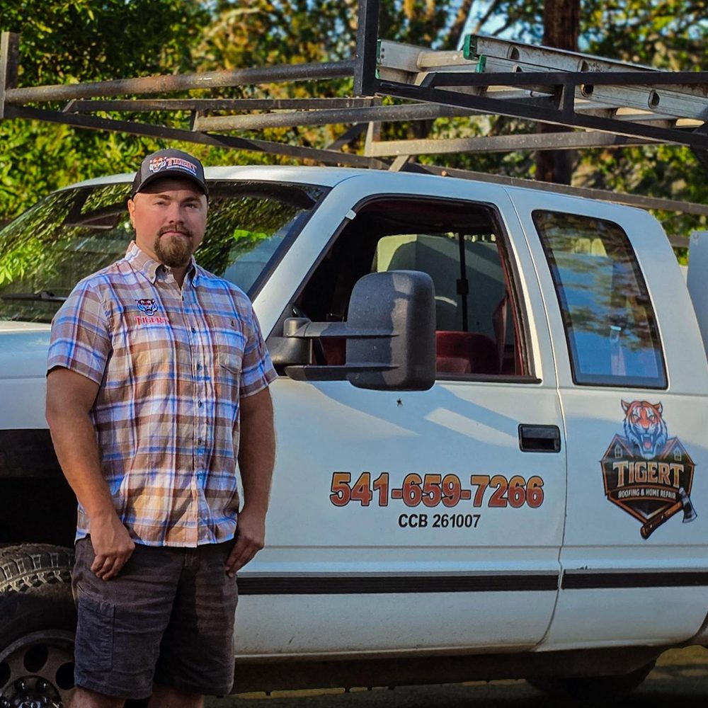 Sam Tigert by his Tigert Roofing truck